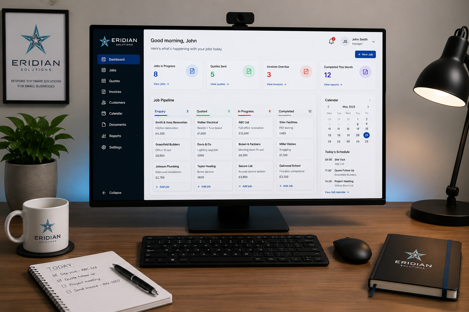 A tidy desk showing a custom Eridian Solutions dashboard on one monitor